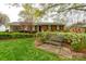 Charming brick home featuring manicured landscaping and inviting front yard bench at 6307 Roanoke Dr # 17, Kannapolis, NC 28081