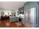 Open kitchen with island and stainless steel appliances looking out to dining area at 6307 Roanoke Dr # 17, Kannapolis, NC 28081