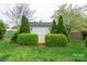 Backyard shed flanked by manicured shrubbery offering storage and charm at 6307 Roanoke Dr # 17, Kannapolis, NC 28081