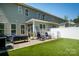 This backyard features well-maintained turf and plenty of outdoor seating at 7036 Heron Rookery Way, Charlotte, NC 28214