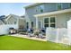 This backyard features well-maintained turf, a grill, and outdoor seating at 7036 Heron Rookery Way, Charlotte, NC 28214