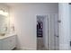 Bathroom with granite vanity, stylish fixtures, and access to walk-in closet at 7036 Heron Rookery Way, Charlotte, NC 28214