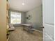 Cozy bedroom with natural light, neutral decor, and a built-in bookcase at 7036 Heron Rookery Way, Charlotte, NC 28214