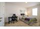 This bedroom features neutral walls, carpeted floors, and a desk at 7036 Heron Rookery Way, Charlotte, NC 28214