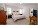 Cozy bedroom features a comfortable bed, natural light, and neutral decor at 7036 Heron Rookery Way, Charlotte, NC 28214