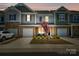 Charming townhome with a one-car garage, stone accents, and well-maintained landscaping at 7036 Heron Rookery Way, Charlotte, NC 28214