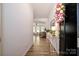 Bright foyer with wood-look flooring, neutral walls, and a glimpse into the open living space at 7036 Heron Rookery Way, Charlotte, NC 28214
