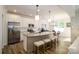 Modern kitchen with stainless steel appliances, granite countertops, and a breakfast bar at 7036 Heron Rookery Way, Charlotte, NC 28214