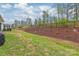 Large backyard with manicured lawn and mulched garden, creating a serene outdoor space at 7662 Tanglewood Way, Denver, NC 28037