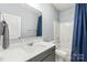 Stylish bathroom with single vanity, gray cabinets, and a shower-tub combo at 7662 Tanglewood Way, Denver, NC 28037