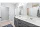 Modern bathroom featuring double vanity with gray cabinets and quartz countertops at 7662 Tanglewood Way, Denver, NC 28037