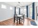 Dining room with hardwood floors, large windows, and a modern light fixture at 7662 Tanglewood Way, Denver, NC 28037