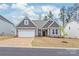 Charming one-story home featuring a two-car garage, gray siding and decorative gable accents at 7662 Tanglewood Way, Denver, NC 28037