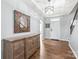 Bright foyer with hardwood floors, tray ceiling, decorative chandelier and wooden console table at 7662 Tanglewood Way, Denver, NC 28037
