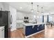 Modern kitchen with an island, white countertops, gray cabinetry, and stainless steel appliances at 7662 Tanglewood Way, Denver, NC 28037