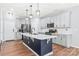 Modern kitchen with an island, white countertops, gray cabinetry, and stainless steel appliances at 7662 Tanglewood Way, Denver, NC 28037