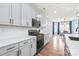 Modern kitchen showcasing gray cabinets, white countertops, and stainless steel appliances at 7662 Tanglewood Way, Denver, NC 28037