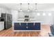Modern kitchen featuring gray cabinets, a blue island and stainless steel appliances at 7662 Tanglewood Way, Denver, NC 28037