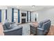 Bright living room with hardwood floors, blue sofas, fireplace, and modern decor at 7662 Tanglewood Way, Denver, NC 28037