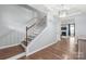 Elegant staircase with hardwood steps and iron balusters at 7662 Tanglewood Way, Denver, NC 28037