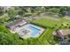 Aerial shot of community pool, showing ample parking, manicured lawns, and lush trees creating a park-like setting at 8308 Knights Bridge Rd, Charlotte, NC 28210