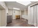 Finished basement laundry and bath area with wood-look flooring, neutral colors, and plenty of storage at 8308 Knights Bridge Rd, Charlotte, NC 28210