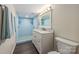 Bathroom featuring double shower heads, a vanity, and a blue-tiled shower at 8308 Knights Bridge Rd, Charlotte, NC 28210