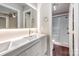 Modern bathroom featuring double sinks, sleek vanity, and glass-enclosed shower at 8308 Knights Bridge Rd, Charlotte, NC 28210