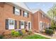 Traditional brick townhouse with black shutters, and a neatly maintained lawn at 8308 Knights Bridge Rd, Charlotte, NC 28210
