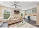 Cozy living room featuring a comfortable sofa, large windows, and a built-in bar area at 8308 Knights Bridge Rd, Charlotte, NC 28210