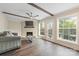 Living room with a cozy fireplace, exposed beams, and hardwood floors at 8308 Knights Bridge Rd, Charlotte, NC 28210