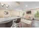 Open-concept living area with a breakfast bar seamlessly connected to a living area and a neutral color palette at 8308 Knights Bridge Rd, Charlotte, NC 28210