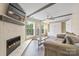 Living room with fireplace, natural light and white-painted brick wall at 8308 Knights Bridge Rd, Charlotte, NC 28210