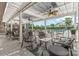 A relaxing covered patio is furnished with comfortable seating areas and ceiling fans, perfect for outdoor lounging at 8308 Knights Bridge Rd, Charlotte, NC 28210
