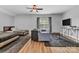 Open bedroom space with twin beds, a sitting area, and large window at 835 Ryans Pl, Fort Mill, SC 29715
