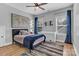 Well-lit bedroom featuring blue curtains, decorative lacrosse sticks, and a wall map at 835 Ryans Pl, Fort Mill, SC 29715
