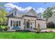 Charming home featuring dormer windows, a covered porch with seating, manicured lawn and a welcoming entryway at 835 Ryans Pl, Fort Mill, SC 29715