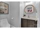 Charming half bathroom with decorative mirror, neutral walls, and modern fixtures at 835 Ryans Pl, Fort Mill, SC 29715