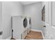 Well-lit laundry room featuring a modern white washer and dryer on platforms at 835 Ryans Pl, Fort Mill, SC 29715