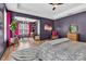 Well-lit main bedroom features a sitting area, modern decor, and dark accent walls at 835 Ryans Pl, Fort Mill, SC 29715