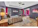 Spacious main bedroom boasts an ensuite sitting area with hardwood floors, a ceiling fan and abundant natural light at 835 Ryans Pl, Fort Mill, SC 29715
