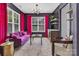 Bright sitting room featuring a purple couch, black accent wall with shelving, and modern lighting at 835 Ryans Pl, Fort Mill, SC 29715
