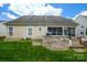 The backyard features a custom stone outdoor kitchen and screened-in patio at 8621 Sequoia Grove Ln, Charlotte, NC 28214