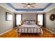 Serene bedroom features tray ceilings with blue accent, hardwood floors and double windows for plenty of light at 8621 Sequoia Grove Ln, Charlotte, NC 28214