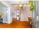 Inviting foyer with hardwood floors, a staircase, and views into other living spaces at 8621 Sequoia Grove Ln, Charlotte, NC 28214