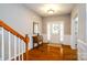 Bright foyer featuring hardwood floors, a stylish table, and a decorative front door at 8621 Sequoia Grove Ln, Charlotte, NC 28214