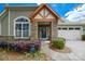 Close up of the charming front entrance with beautiful stone accents and covered porch at 8621 Sequoia Grove Ln, Charlotte, NC 28214