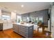Open concept kitchen with island, stainless steel appliances, and easy access to the living area at 8621 Sequoia Grove Ln, Charlotte, NC 28214
