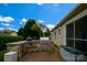 A stone outdoor kitchen with a grill, undercounter refrigerator and patio area at 8621 Sequoia Grove Ln, Charlotte, NC 28214