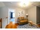 Sitting area featuring hardwood floors, comfortable seating, accent rug, and artwork at 8621 Sequoia Grove Ln, Charlotte, NC 28214